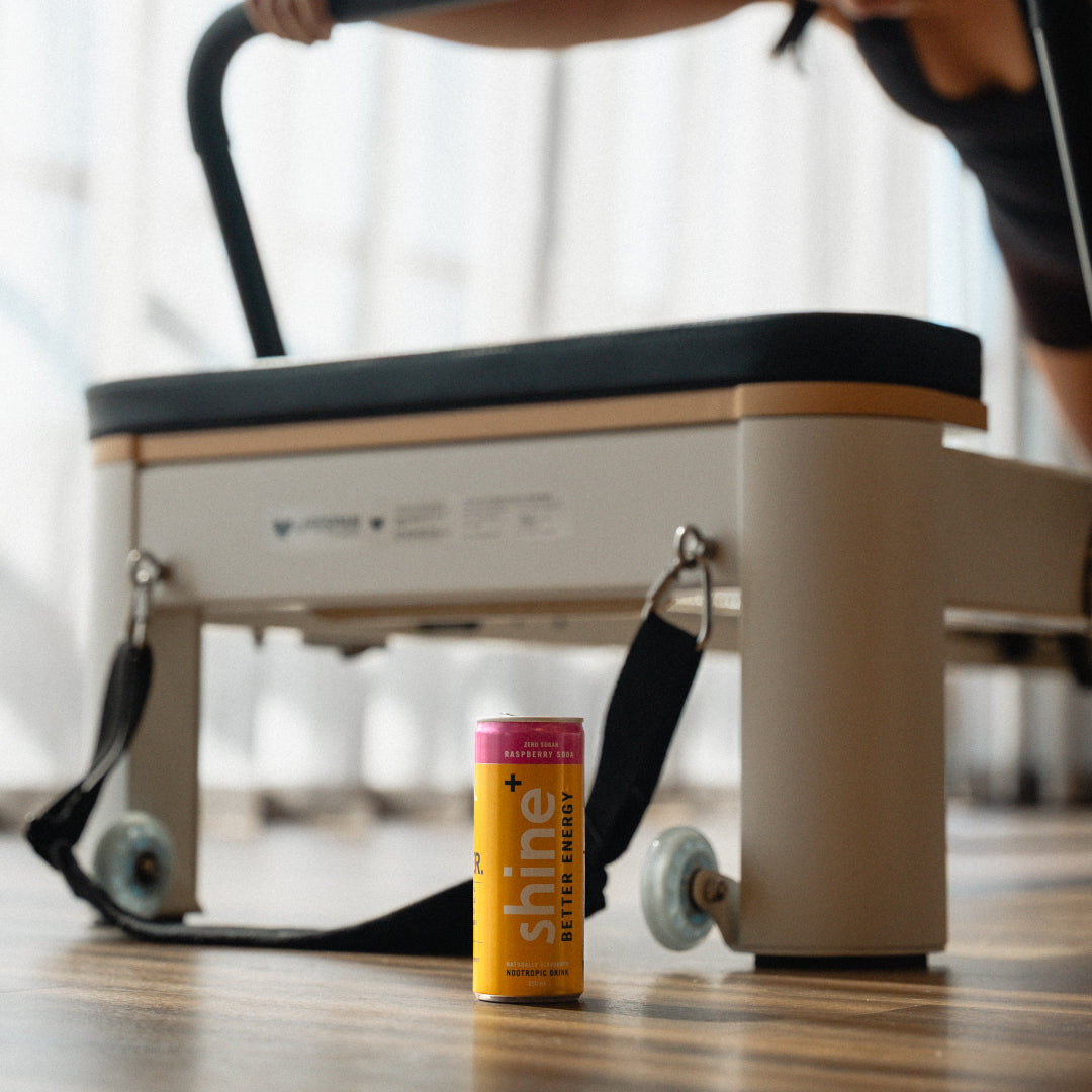 A Shine Better Energy can on a pilates studio floor